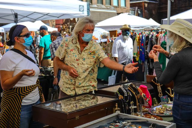 People browse the newly reopened open-air Chelsea Flea Market